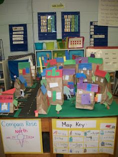 a desk with many pieces of paper on top of it and some school supplies in the background