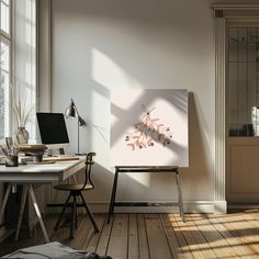 an easel is sitting in front of a painting on the wall next to a desk