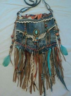 an old purse with fringes and beads hanging from it's side on a white sheet