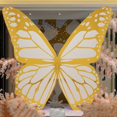 a large yellow butterfly sitting on top of a display