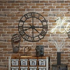 a brick wall with a clock and other items on it next to a wooden crate