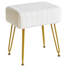 a white foot stool with gold legs