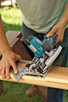 a person using a power tool on a piece of wood