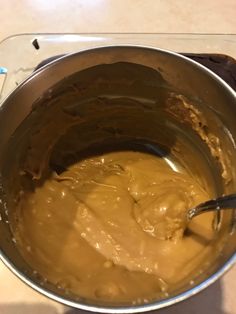 a metal bowl filled with batter on top of a counter