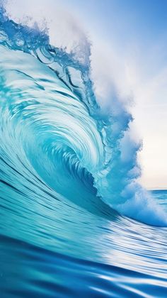 a large blue wave is breaking in the ocean