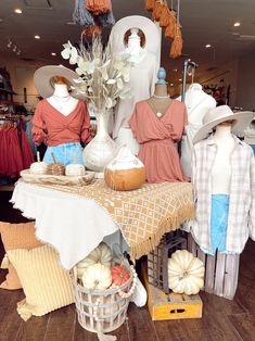 an assortment of clothing and hats on display in a store