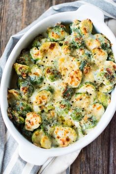 broccoli and cauliflower casserole in a white dish on a wooden table