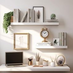 a laptop computer sitting on top of a white desk next to books and other items