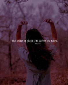 a woman standing in the woods with her arms up and hands behind her head, saying the secret of blush is to accept the laws