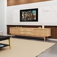 a flat screen tv mounted to the side of a wooden cabinet in a living room