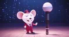 a cartoon mouse is standing next to a lamp post and wearing a red suit with white polka dots on it