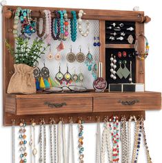 a wall mounted jewelry rack with earrings and bracelets hanging on it's sides