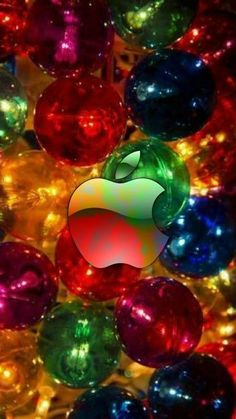 an apple logo surrounded by many shiny balls