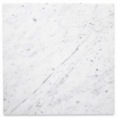 a white marble tile with black dots on it