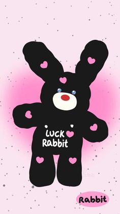 a black teddy bear with hearts on it's chest and the words luck rabbit