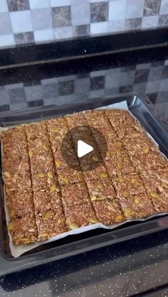 a pan filled with granola bars on top of a stove next to a frying pan