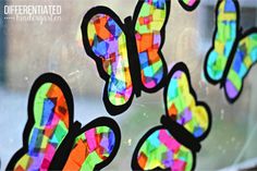 colorful paper butterflies are hanging on a window sill with the words, different colored shapes and sizes