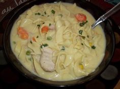 a bowl filled with pasta and vegetables on top of a table