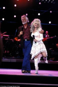 an image of a man and woman dancing on stage at a concert photo by globe photos inc