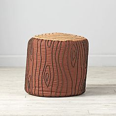 a wooden stool sitting on top of a hard wood floor next to a white wall