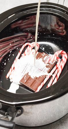 candy canes are being poured into an air fryer