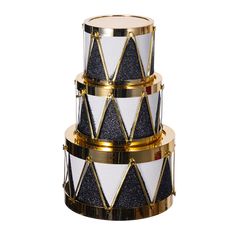 three tiered black and white cake with gold trimmings on the sides,