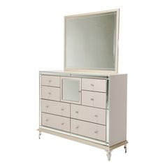 a white dresser with a mirror on top and drawers below it, in front of a white background