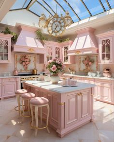 a pink kitchen with two stools and a large clock on the wall above it