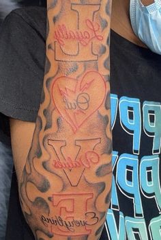 a person wearing a face mask and holding up a large arm tattoo with words on it