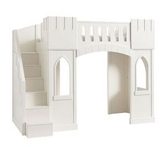 a white doll house with stairs leading up to it