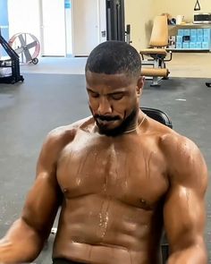 a man with no shirt on in a gym