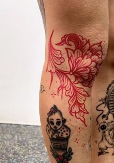 a man's legs with tattoos on them