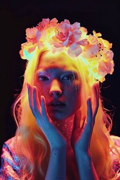 a woman with long blonde hair and flowers on her head is posing for the camera