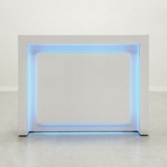 a white box with blue lights on the sides and a square opening in the middle