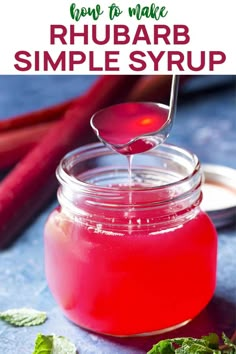 a jar filled with rhubarb syrup and garnished with mint leaves