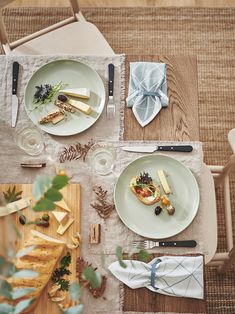 an overhead view of a table set with plates and utensils, napkins and silverware