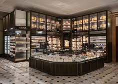 an empty bakery with lots of food in the display case and shelves full of pastries