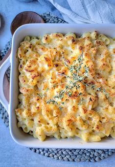 a casserole dish with macaroni and cheese topped with fresh thyling