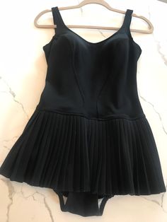 This swimsuit is amazing! Made by Nelbarden of England.. this is a European size 36. This would be a modern small.  Everything looks in great condition. There is a built in  bra, A beautiful accordion skirt attached... A little dropped waist which is very flattering. This brings me right back to the poolside with Frank Sinatra..✨❣️ Please note pictures for any flaws. This is pre-loved and so it is not perfect. This has been laundered and is ready to wear. There seems to be some white flaking on the fabric of the bra on the interior. Very minor. This is a keeper for any vintage affair... Or even a great photo shoot🙌 Pool Swim Dress Lined, Fitted One-piece Swimwear For Evening, Fitted Sleeveless Lined Swim Dress, Fitted Sleeveless Lined Tankini, Fitted Lined Swim Dress For Poolside, Fitted Swim Dress For Pool With Lined Body, Fitted Lined Swim Dress For Beachwear, Fitted One-piece Lined Tankini, Fitted One-piece Lined Swimwear