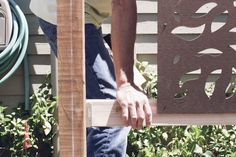 a man is working on a piece of wood