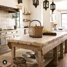 a large wooden table sitting in the middle of a kitchen