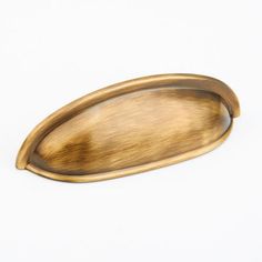 an oval brass plate on a white background