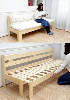 a woman sitting on the floor next to a bed with wooden slatted frame