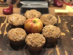 muffins and an apple on a wooden table