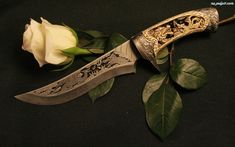 a knife with a white rose on it