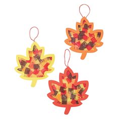 three autumn leaf shaped decorations hanging from strings