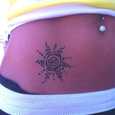 a woman's stomach with a tattoo design on the side of her belly,