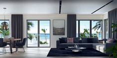 a living room filled with furniture and lots of windows next to the ocean in front of it