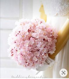 a bouquet of pink flowers sitting on top of a dress