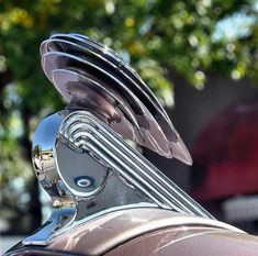 the front end of a motorcycle with chrome parts on it's head and tail